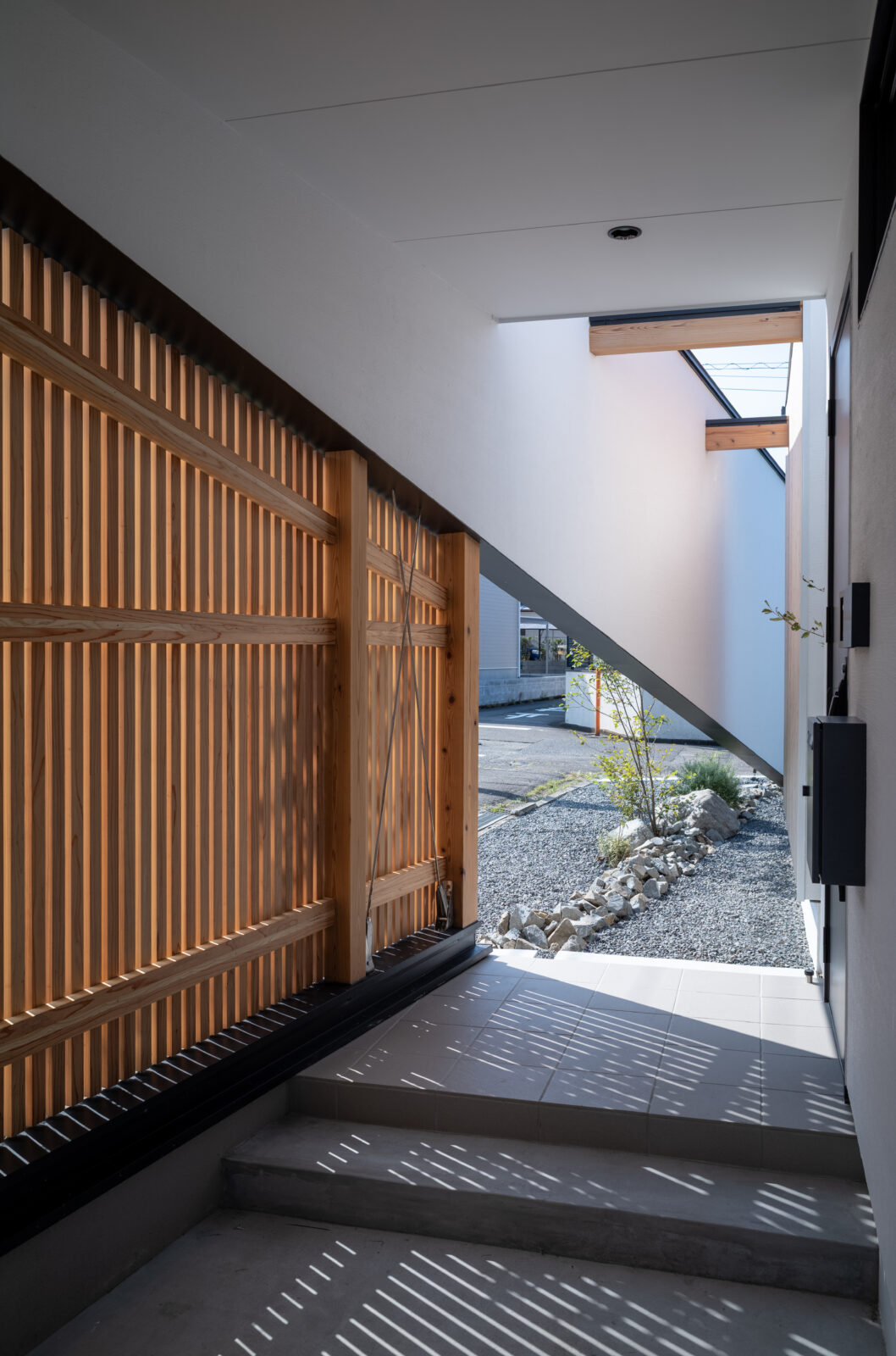 街の喧騒を美しく遮るコートハウス。光と緑に包まれるカーテンレスの平屋 写真